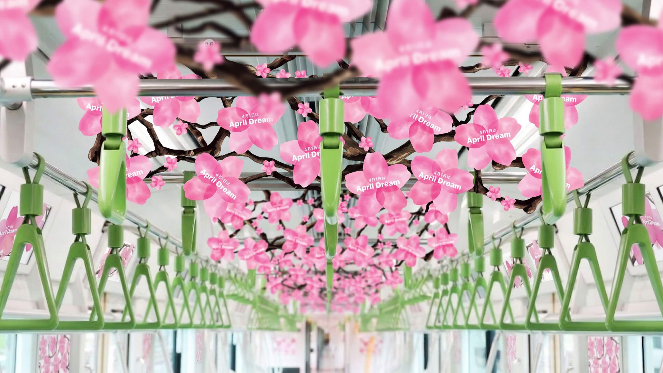 山手線内吊り下げ広告のイメージ写真_桜の花を模した造形が幾重にもぶら下がる